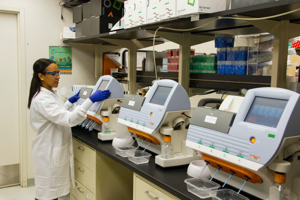 Lab technician using gene sequencing machines